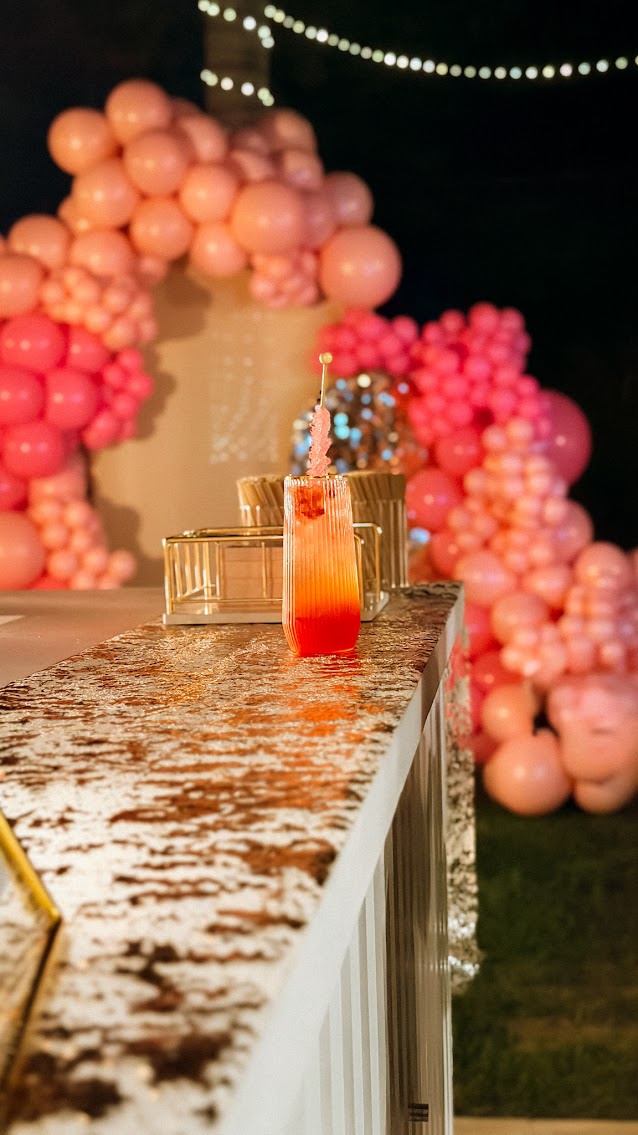 Signature drink with balloon backdrop