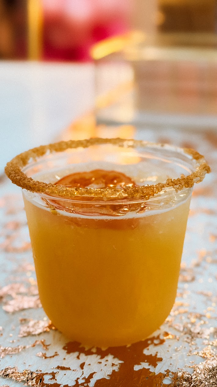 Golden citrus drink with sugar rim