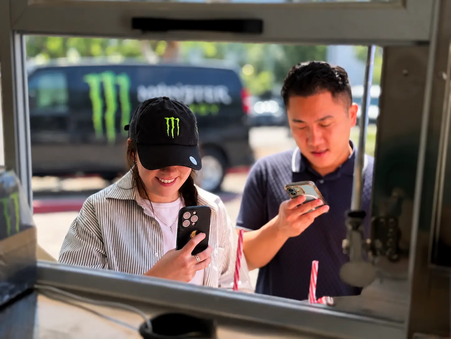 guests in monster energy caps ordering at a brand activation beverage window