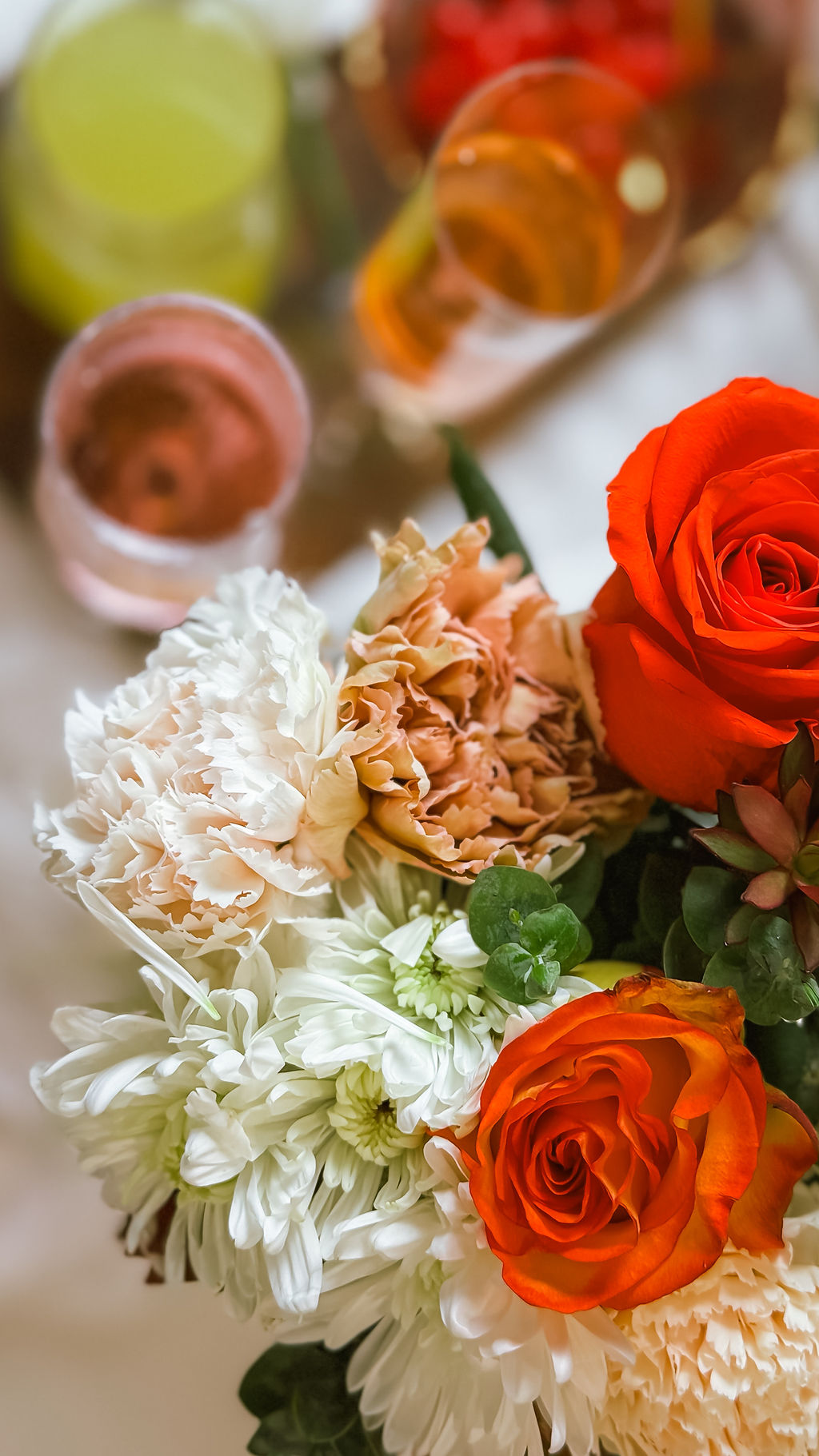 Floral arrangement with elevated non-alcoholic beverages at a styled event