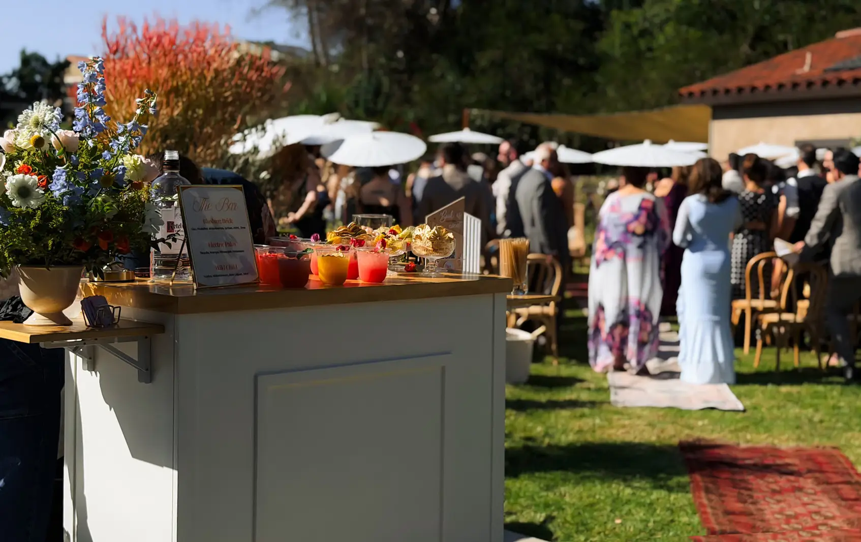 Outdoor wedding reception tables styled with colorful mocktails and floral arrangements in Redlands, California